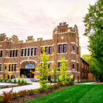 Historic brick building with green landscaping.